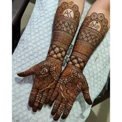 A stunning example of personalized engagement henna, this design incorporates the couple's initials 'AK' and name 'Kshitij' into the intricate wristbands.