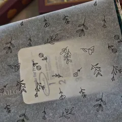 A close-up of the custom tissue paper and personalized sticker for a Roka order. These small, bespoke details are part of what makes the gifting experience so special and unique.