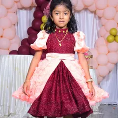 A straight-on view of the birthday frock. You can see the high-neck collar and the way the satin belt cinches the waist before the skirt flares out. It's a design that's both playful and elegant.