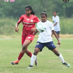 Our player shields the ball from an opponent during a Women's Premier League match, showcasing strength and control in a tight situation.