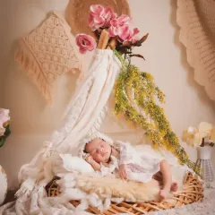 An example of our boho-themed sessions, featuring soft lace, a wicker basket, and delicate floral elements. We create these artistic, light-filled portraits for a timeless and elegant look.