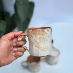 This Shino coffee cup holds about 275ml, the perfect size for a cappuccino. The faceted sides feel great to hold, and the Shino glaze has a beautiful, subtle texture.
