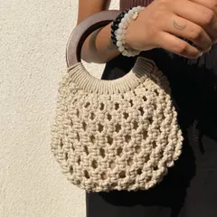 We love the elegant simplicity of this macrame bag with a solid wooden handle. It’s a structured, boho-chic piece that works for brunches, dinners, and everything in between. It also comes with a jute pouch inside to keep your essentials secure.