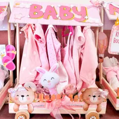 This carriage was designed as a mini closet, with tiny pink baby clothes hung neatly inside. It's a creative and practical way to gift newborn apparel.