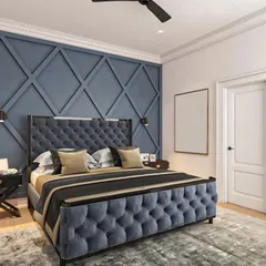A bold and dramatic bedroom with a deep blue, tufted velvet bed and a matching geometric accent wall. The design creates a sophisticated and regal atmosphere, perfect for a master suite.
