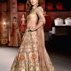 Kriti Sanon strikes a powerful pose on the ramp, highlighting the silhouette of her elegant couture lehenga against the dramatic backdrop of the fashion show.