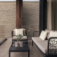 This intimate courtyard at the Carbonado residence demonstrates our focus on creating private outdoor spaces. The textured stone wall and minimalist furniture offer a serene corner for relaxation, seamlessly connected to the interior.
