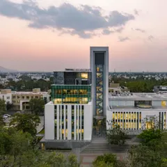 An evening view of the Sona University Centre, featured in ArchDaily. The lighting design highlights the building's modern form and its role as a beacon of innovation and learning on the campus.