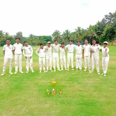 A proud team photo with their championship trophy on the field.