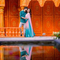 I love blending tradition with a modern, artistic eye. Here, the vibrant colors of the couple's outfits and the stunning architecture are doubled in the water's reflection, creating a perfectly symmetrical and colorful pre-wedding portrait.