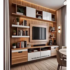 A perfect example of a full-wall entertainment center that provides maximum storage. This modular design incorporates bookshelves, cabinets, and a dedicated space for a soundbar, all tied together with warm wood and white finishes.
