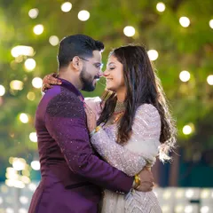 An intimate portrait of Abhilash and Jagruti, using the warm glow of fairy lights to create a romantic ambiance. This shot is perfect for capturing the magic of an evening celebration.