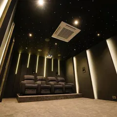 This luxury 7.2.4 home cinema in Chennai showcases a dramatic, angular design. The starlight ceiling and vertical LED lighting strips create a sense of depth and immersion, perfectly complementing the powerful 4K projection on the Grandview 135-inch screen.