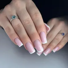 Clean and classic French tips on perfectly shaped square nails. A timeless look that shows off healthy, well-manicured hands.