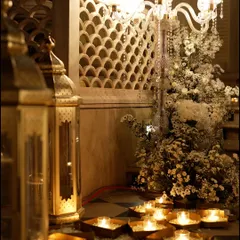 A detail of the lighting for the all-white Sufi night. Ornate lanterns and candles were placed on the floor, illuminating the intricate jaali work and floral arrangements from below.