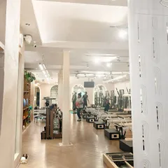 A glimpse into the studio's open and airy layout. The clean lines, herringbone floors, and ample space ensure you can move freely and comfortably, fully immersing yourself in your practice.