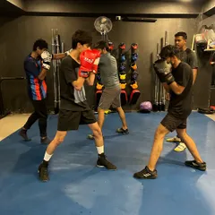 We train as a tribe. Here, a group of new and intermediate members work on their boxing stance and basic punches. Everyone starts somewhere, and we build the foundation together.