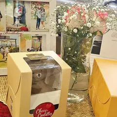 A heartfelt birthday surprise for him, featuring a custom photo collage frame, a delicious chocolate dessert, a bouquet of flowers, and a personal note.