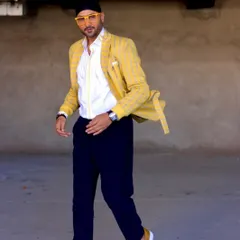 Another angle of Harbhajan Singh in the yellow blazer set. The combination of the bright jacket with dark trousers creates a balanced and modern semi-formal look.