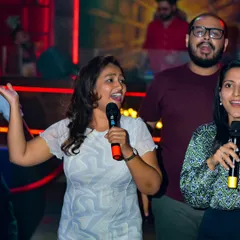 A group performance in full swing. There's nothing like singing a classic anthem with your friends, and I always encourage group numbers to get more people involved.