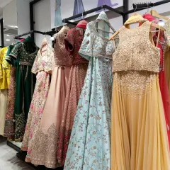 A rack dedicated to designer lehengas and crop-top sets. You can see a wide range of colors and styles, from heavily embellished to light and breezy.