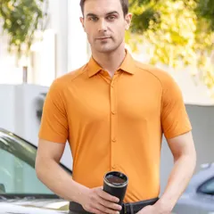 A close-up shot of a male model in a fitted apricot-colored shirt, holding a coffee tumbler. This image focuses on the texture and fit of the garment, ideal for product detail pages on an e-commerce site.
