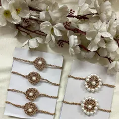 My elegant pearl handmade crochet rakhis are crafted with a beautiful golden thread. You can see two variations here, one with a simple pearl center and another with a full pearl border.