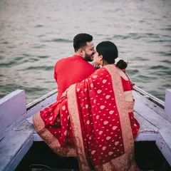 An intimate moment on the boat, with the Ganges river as the backdrop. This candid couple portrait captures a shared laugh, reflecting the easy chemistry and joy between them during their destination pre-wedding shoot.