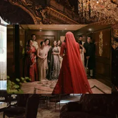 The first look. We framed this shot from a distance to capture not just the bride's reveal, but the emotional reactions of her entire family. It’s a powerful storytelling image, set against the opulent interiors of the palace hotel.