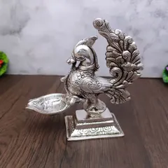 This antique German silver peacock diya is one of my most popular items. The detailed carving on the peacock and its elegant stance make it a shandaar addition to any pooja room, lighting up your space with grace.