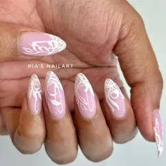 A closer view of the detailed white lace nail art, showing the fine lines and patterns that make this design so special.