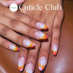 A bright and cheerful design with a pink and orange ombre tip, decorated with hand-painted white flowers.