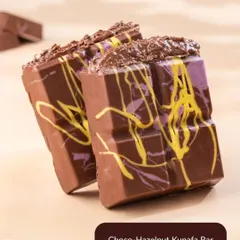 A close-up of my Choco-Hazelnut Kunafa Bar. This decadent treat features a rich hazelnut filling inside a smooth chocolate bar, offering a delicious twist on the viral dessert.
