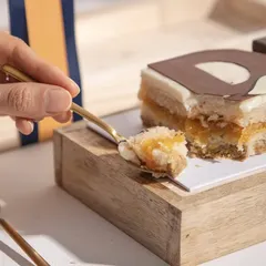 A spoonful of our Father's Day cake, showing the light, fruity layers inside. A limited-edition dessert to celebrate the sweetest hero.