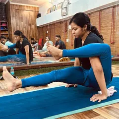 Our teacher training course focuses on mastering advanced asanas. This student demonstrates a challenging arm balance, showcasing the strength and skill developed during the program.