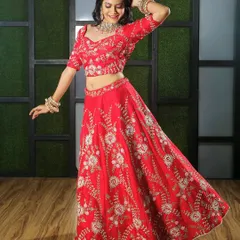 A playful, dynamic pose in the studio to showcase how the lehenga moves. This shot is great for social media content, showing the outfit in a fun and engaging way while still highlighting the detailed floral embroidery on the red fabric.