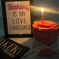 A different kind of floral cake. This one is shaped like a single, large rose, crafted from fondant. It's a beautiful and unique centerpiece.