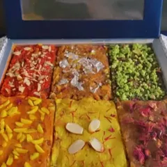 My Halwa Brick Platter offers a modern take on traditional Indian sweets. It features different varieties of rich, delicious halwa, garnished with nuts, saffron, and edible silver leaf.