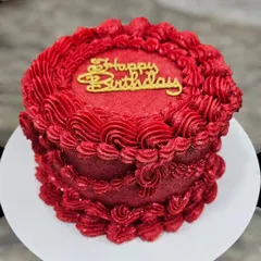 A striking monochrome red vintage cake. I teach how to achieve this vibrant color in buttercream and use different piping tips to create a variety of textures and patterns.