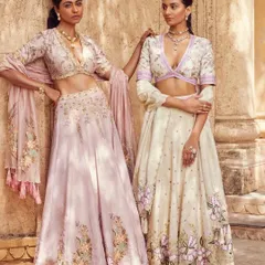 A campaign image for Wedding Asia, featuring two models in soft pastel lehengas. The composition and styling evoke a sense of romance and sisterhood.