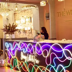 The reception desk for the store launch, featuring a custom neon sign with the brand's tagline "Young, Wild & Free". This element immediately communicated the fun and energetic vibe of the event.