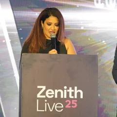 Focused at the podium during Zenith Live 25. When hosting a tech conference, it's crucial to deliver information clearly and keep the energy high for an audience of thousands.