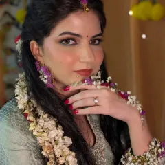 A beautiful portrait from Bhawna's Haldi ceremony. She is adorned with floral jewelry, and her makeup is kept fresh and minimal to let her natural glow shine through.