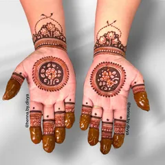 A classic and elegant mandala design on the palm. The central floral mandala is surrounded by a thick border, with a matching lotus cuff and detailed finger work.