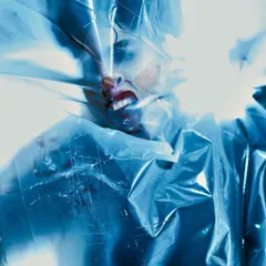 Part of a series exploring themes of suffocation and breaking free. The model is wrapped in plastic, with a single, hard light source creating a ghostly, abstract silhouette.