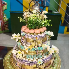 Another angle of the 25th anniversary cash cake, showing the floral topper and butterfly details. I can customize the theme and amount for you.
