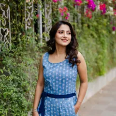 A lovely outdoor portrait with vibrant bougainvillea flowers in the background. This shot adds a pop of color and a fresh, natural feel to the actress's portfolio.