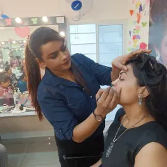 Here I am working closely with a student during a makeup workshop. I believe in providing direct, personal guidance to ensure every student understands the techniques being taught.