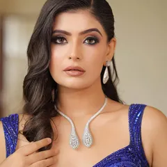 A close-up of the "Blue Lagoon" look. This shot highlights the intense smokey eye makeup and the flawless, glowing base that makes the whole look pop.