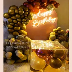 The neon sign is nestled within the balloon arrangement, creating a seamless and integrated design.